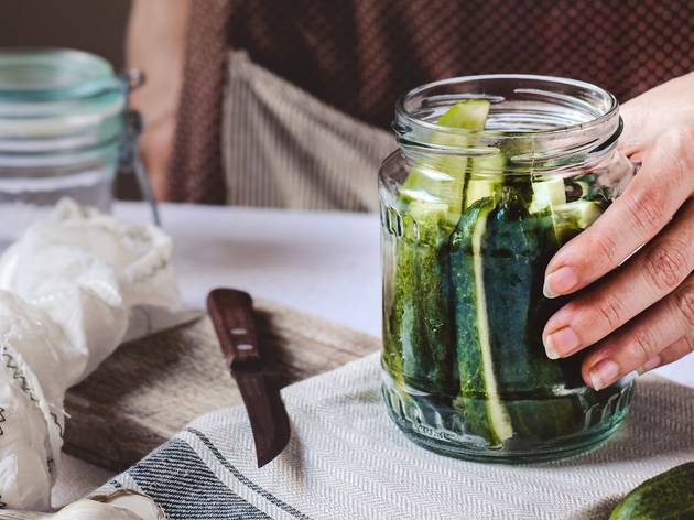 Pickles and pickling Close up of person making pickles in a jar.