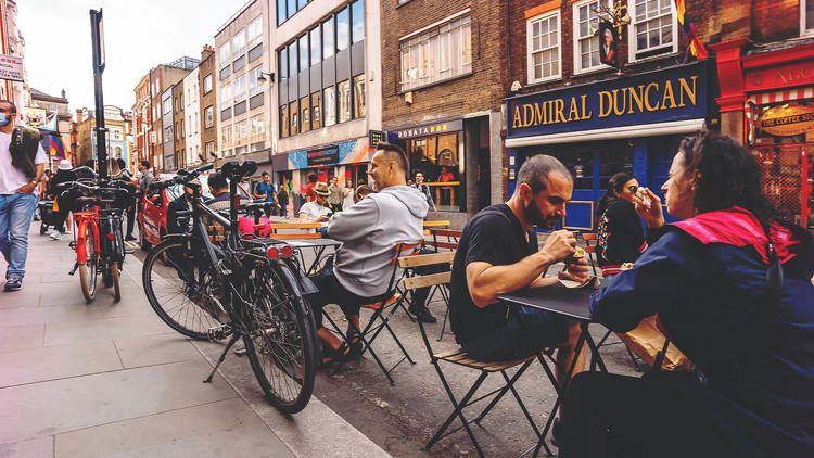 people eating and drinking in soho outside