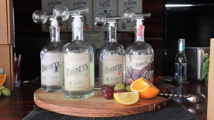 Four bottles of Fossey's Gin with wedges of orange and lemon