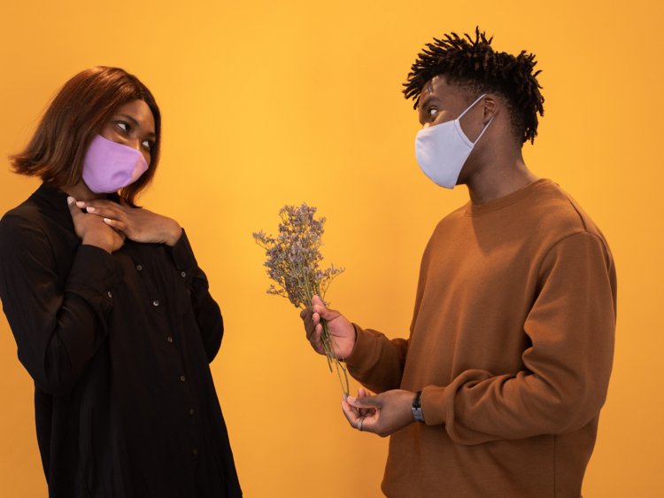 Two people with masks going on a date. 