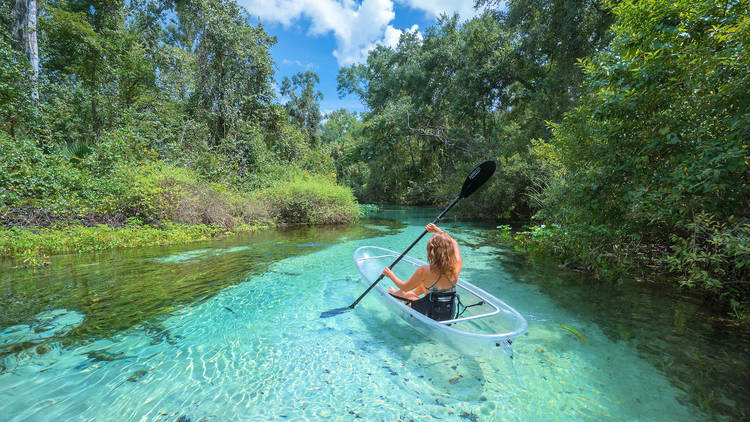 Woman kayaking in a blue spring