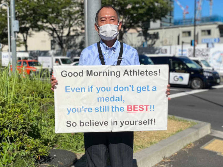 This man stands outside the Tokyo Olympic Village every day to motivate athletes