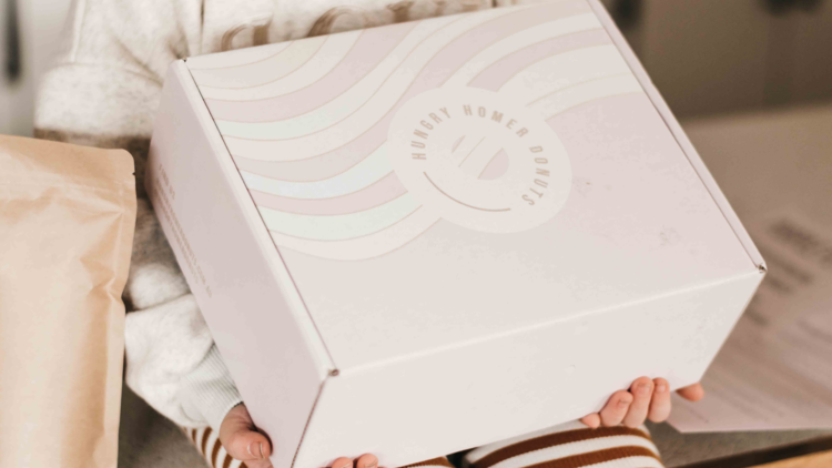 A child holding the DIY donut making box. 