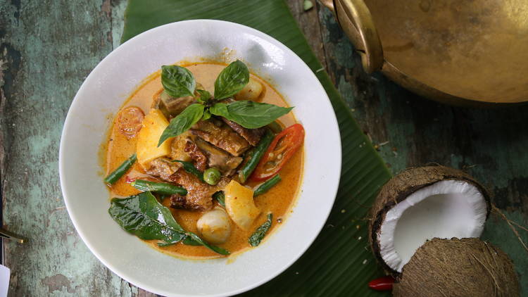 A big bowl of curry loaded with fresh chilli and Thai herbs 