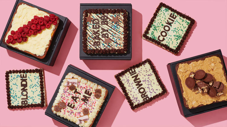 A selection of brownie slabs with the words "Eat Me" written on top