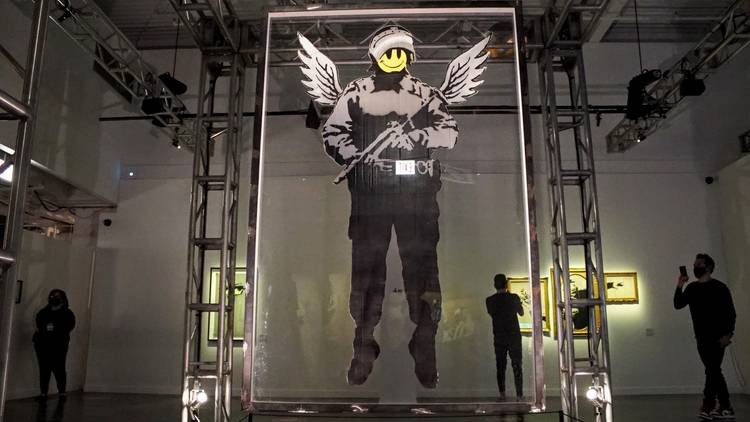 The Art of Banksy street art on glass inside the exhibit