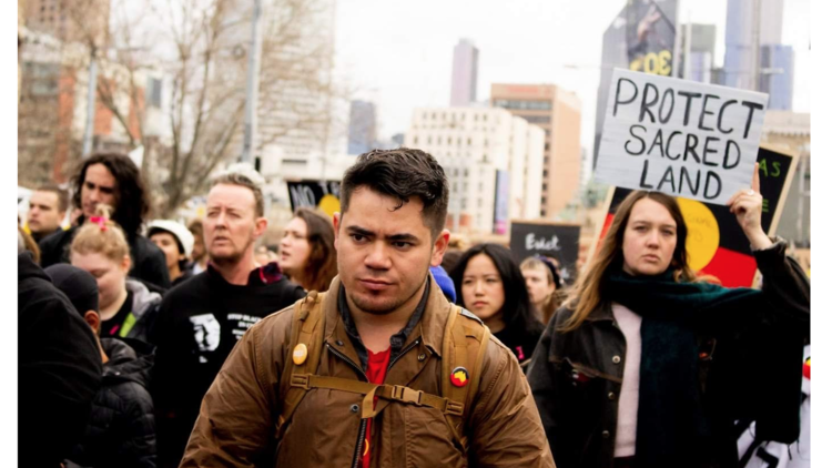 Christopher Jakobi at a climate rally with Indigenous climate organisation Seed