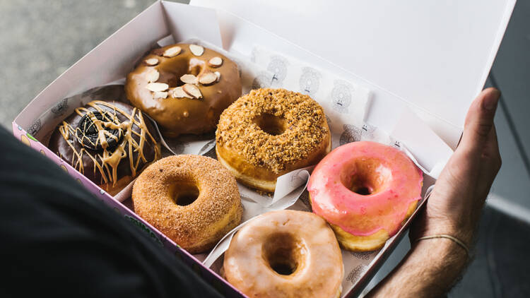 A selection of Grumpy Donuts doughnuts in a pink box