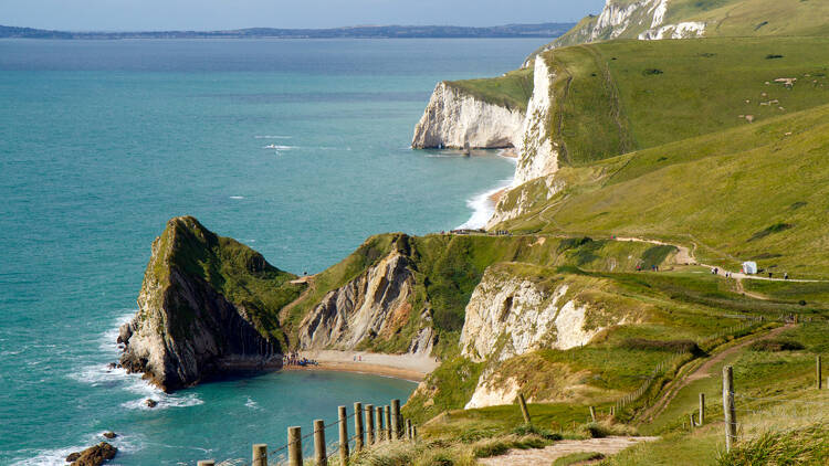 Coastal path on jagged cliffs overlooking beautiful turquoise sea