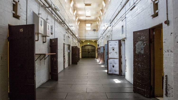 A corridor with cell doors open at Old Melbourne Gaol