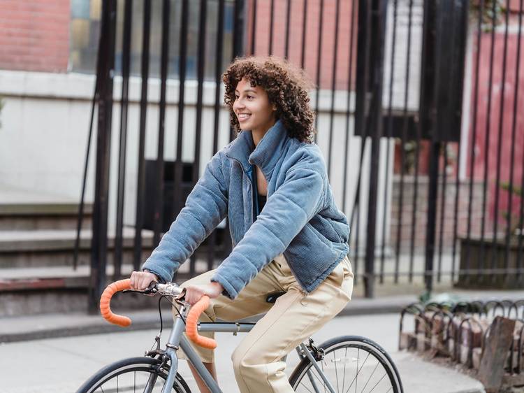 A woman riding a bike in her neighbourhood. 