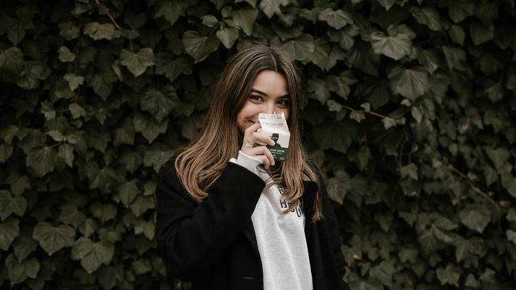 A young woman drinking iced coffee