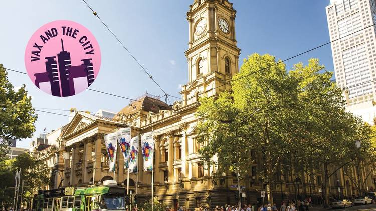 Melbourne Town Hall in the daytime. A tram is running alongside it and a sticker that says "vax and the city" is imposed over the top of the image