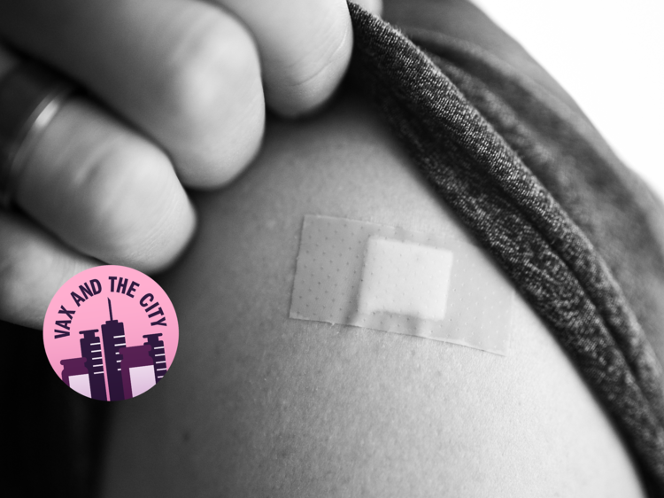 A black and white photo, close up of someone's shoulder with a band-aid