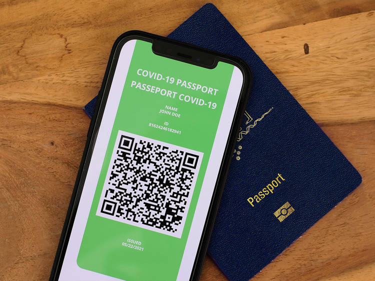 A phone screen with a QR code lays on top of a dark blue Australian passport