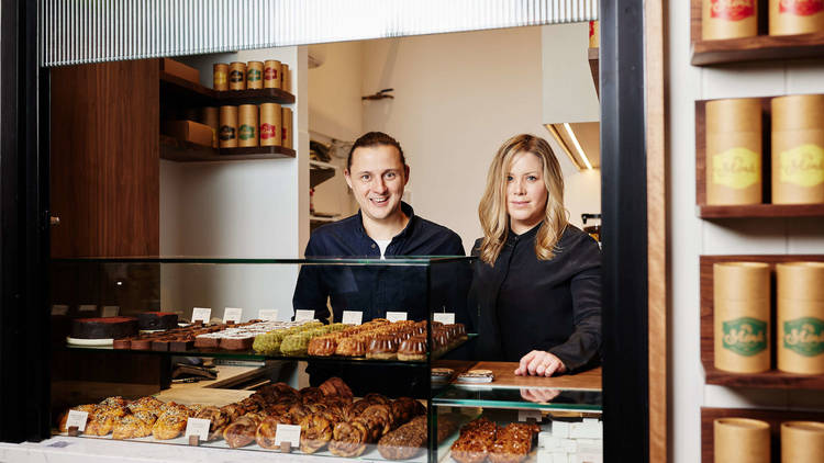 Two people stand in shopfront for Mork Chocolate