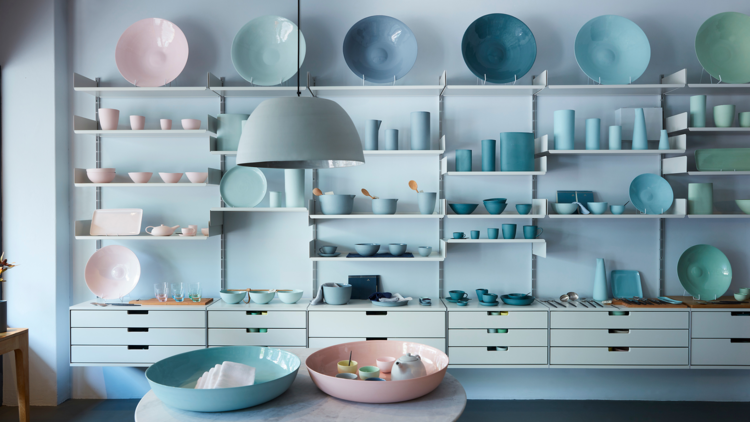 Bowls and crockery lined up on shelves in shop