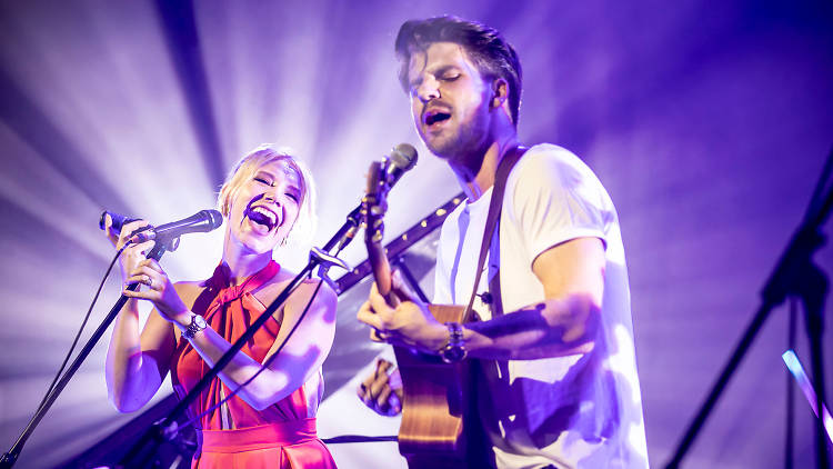 Musicians Jess & Matt playing guitar and singing on stage