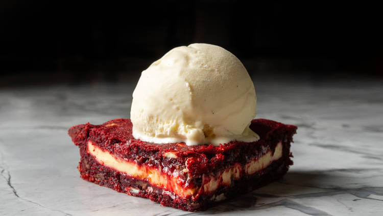 Messina red velvet cookie pie topped with ice cream