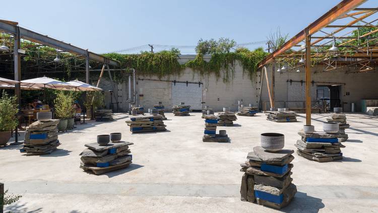 Lorna Simpson Stacked Stones/Vibrating Cycles 2021 Bluestone, wood, paint, black obsidian singing bowls, mallets, 15 stacks Installation view, ‘Lorna Simpson. Everrrything,’ Hauser & Wirth Los Angeles, 2021.