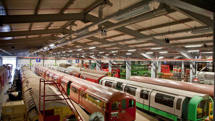 Vintage tube vehicles lined up in a large warehouse