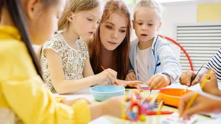 Woman withh small children making crafts