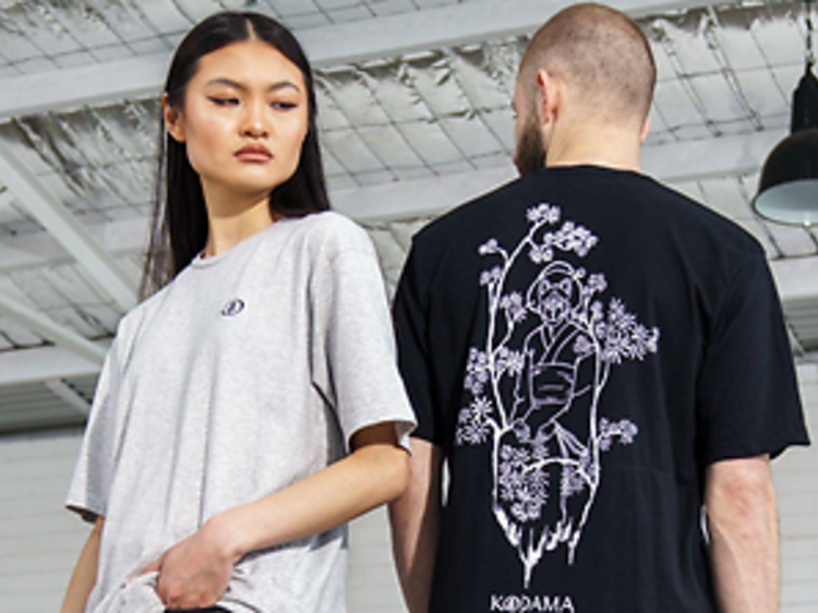 A woman and a man wearing shirts by Kodama Apparel.