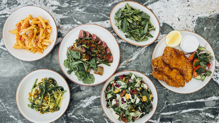 A selection of Great White Larchmont's food, including steak, pasta, salad and chicken schnitzel. 