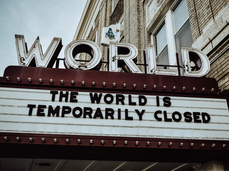 A cinema announcement board reads The World is Temporarily Closed