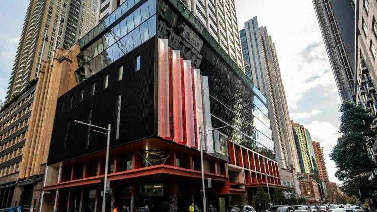 An exterior view of City of Sydney Creatives Studios with a cool orange angular glass facade 