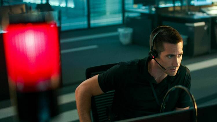 Jake Gyllenhaal wearing a phone headset as a 911 emergency call operator in Netflix film The Guilty