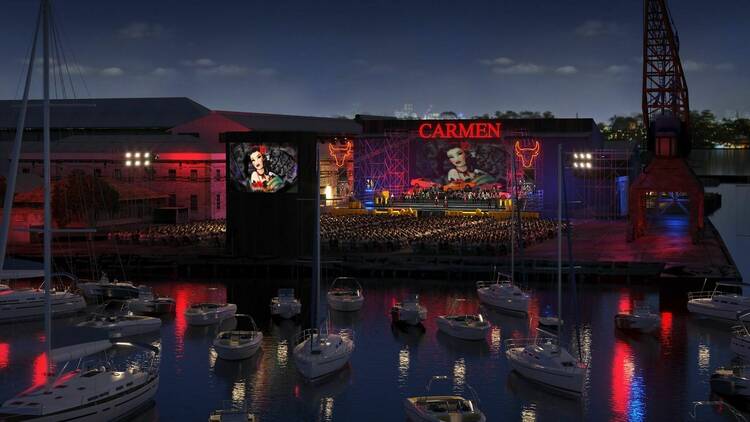 A computer graphic of what Opera Australia's Carmen stage will look like on Sydney harbour's industrial surrounds of Cockatoo Island with boats on the water surrounding it