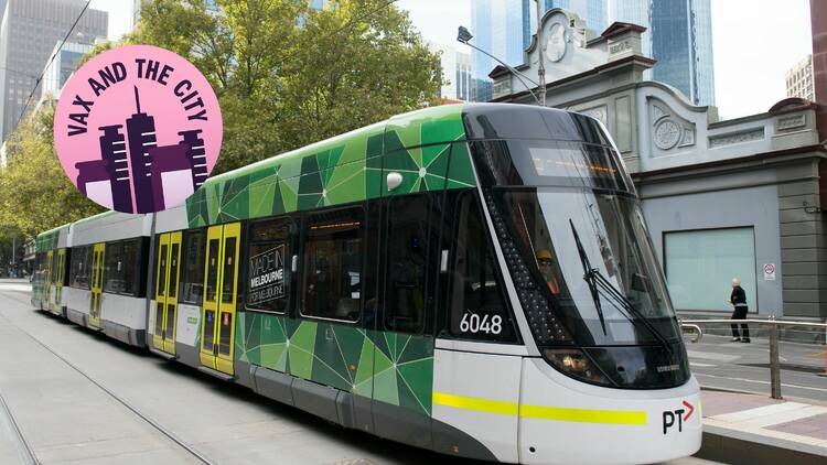Melbourne green and white tram with Vax and the City sticker