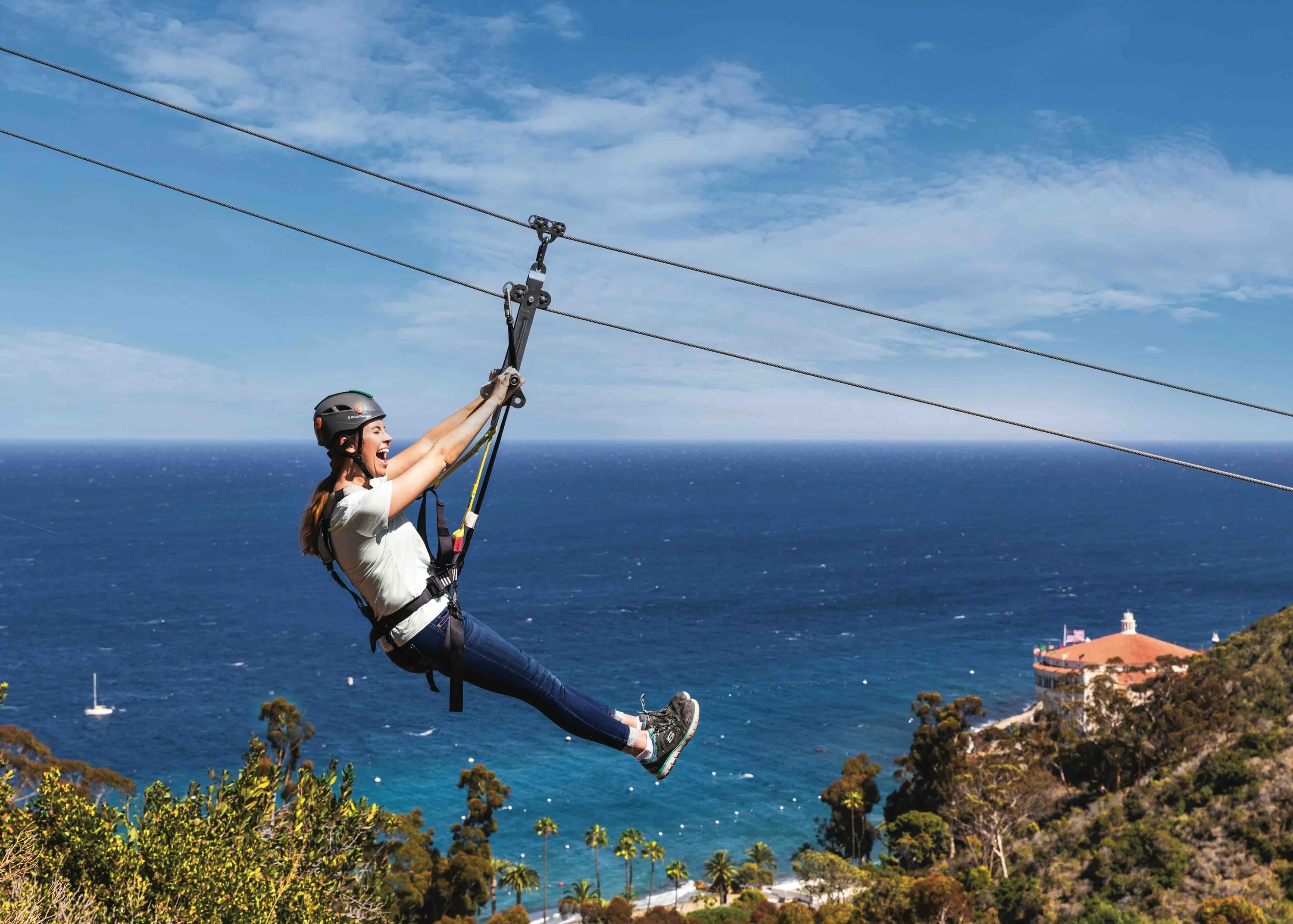 A woman zip-lining through the air over Photograph: Courtesy of Catalina Island
