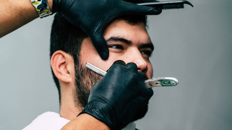 A man getting his face shaved.