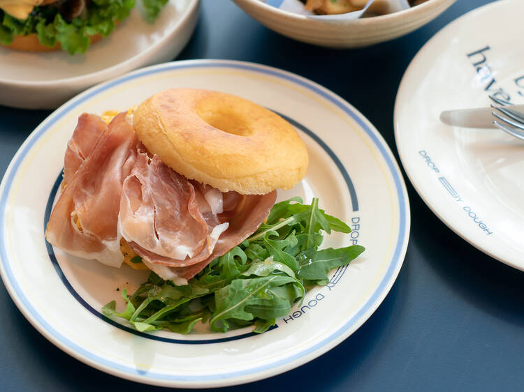 Doughnut sandwich served with Scrambled eggs & Prosciutto 