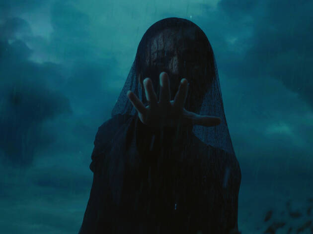 Sunod, A Night of Horror 2021 A dark veiled woman in funeral garb reaches out menacingly with a stormy sky behind her