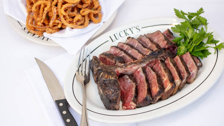 A medium rare steak and skinny onion rings at Lucky's Malibu.