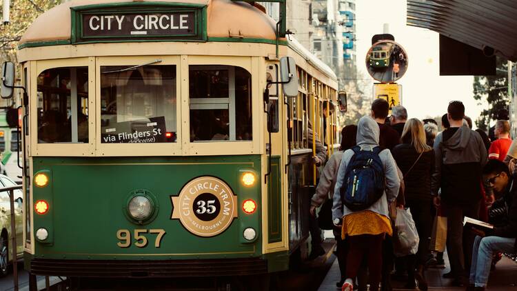 People boarding a busy city circle tram in Melbourne