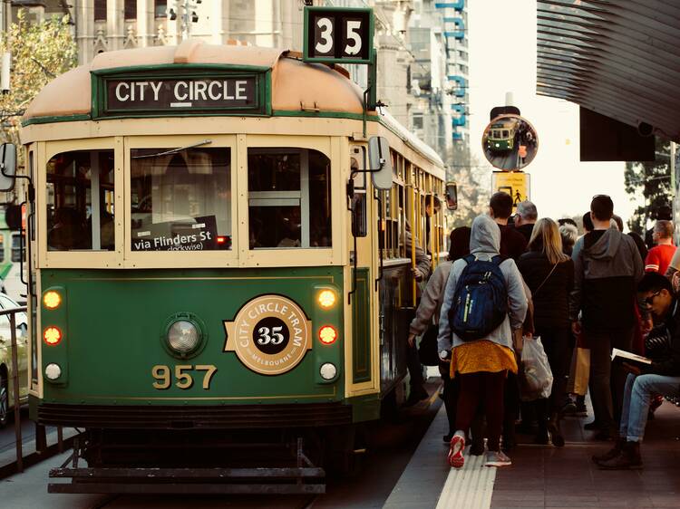 People boarding a busy city circle tram in Melbourne