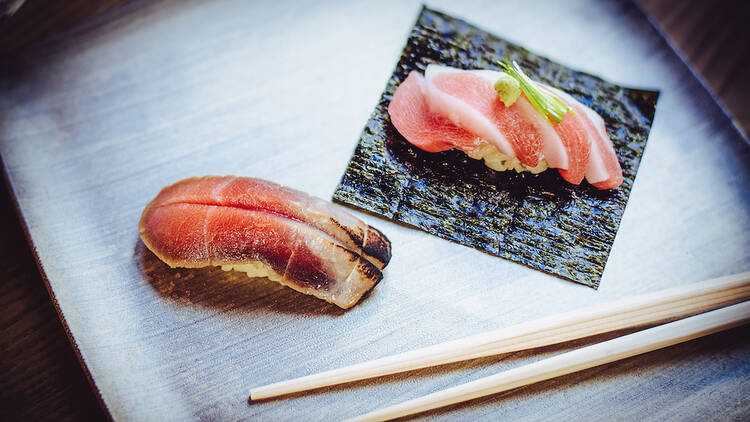 An image of sushi and chopsticks from SF's KUSAKABE restaurant.
