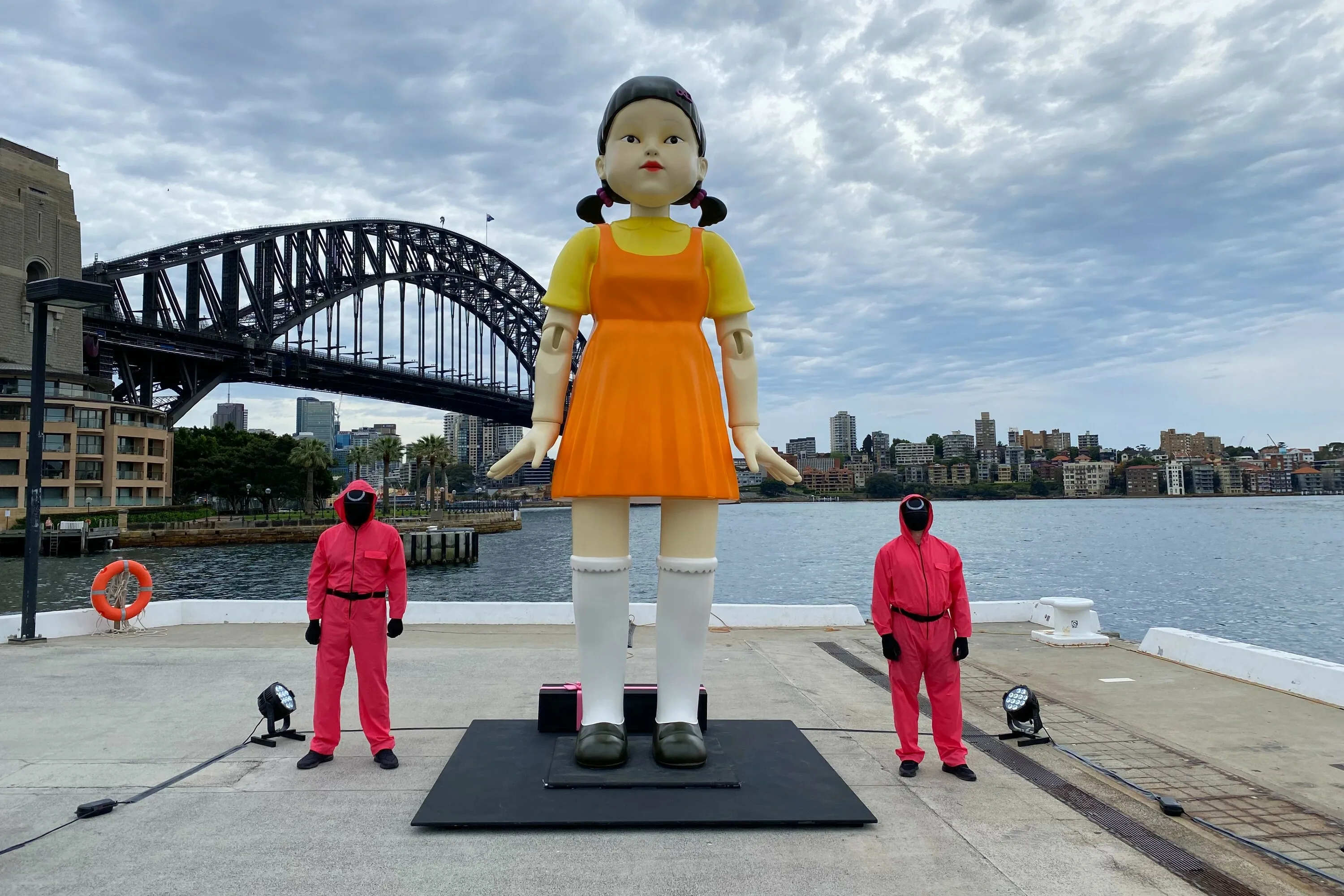 The Red Light Green Light Girl from Squid Game stands by Sydney Harbour