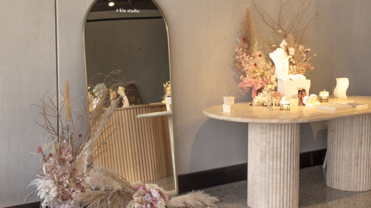 A mirror, table and bouquets inside S-kin Studio Jewelry's Richmond location.