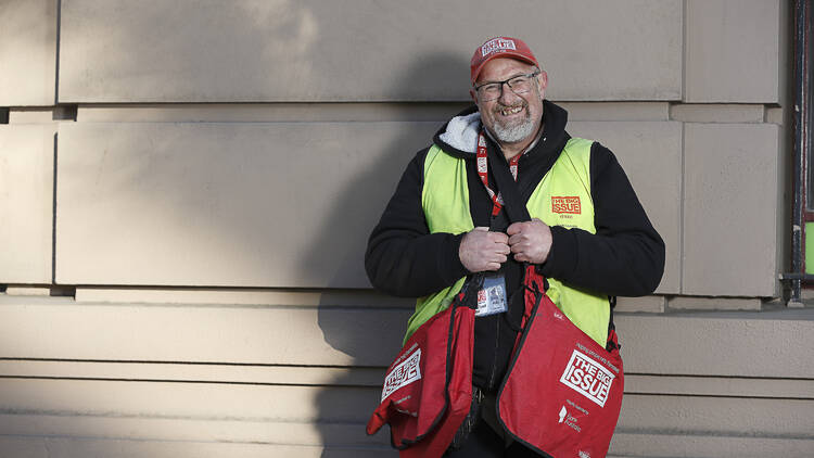 A man selling magazines from the Big Issue.