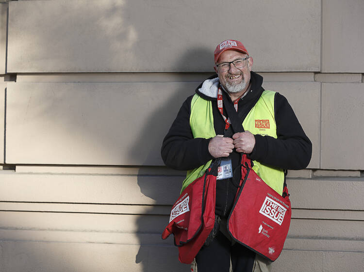 A man selling magazines from the Big Issue.