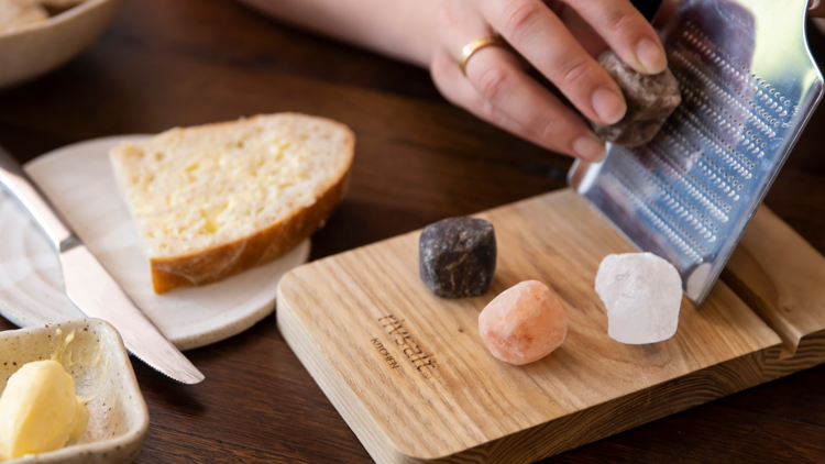 A wooden plate with four types of rock salt
