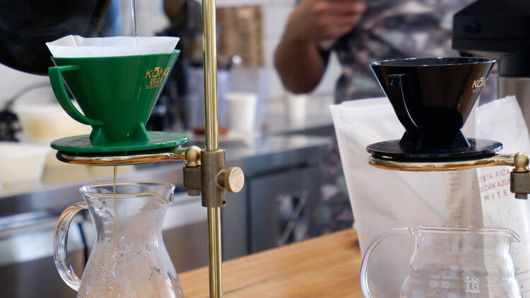 Two coffee filters drip fresh coffee into glass pots at the Ashfield Apothecary