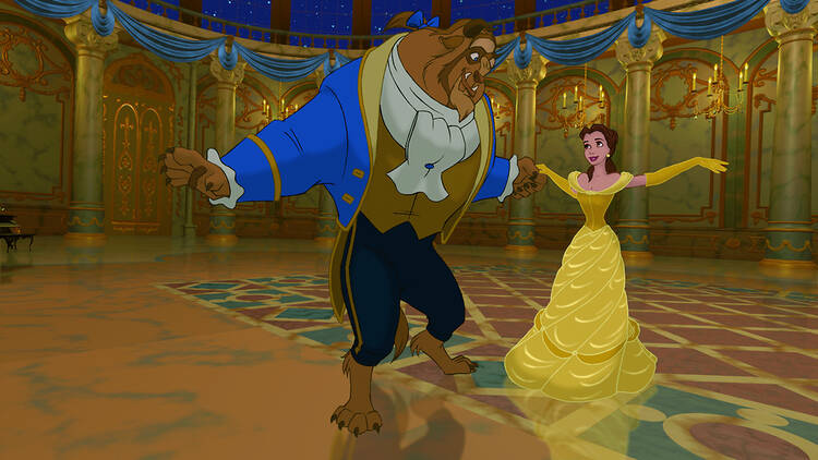 An animation still shot from the Disney film Beauty and the Beast, depicting the Beast dancing with Belle in a ballroom