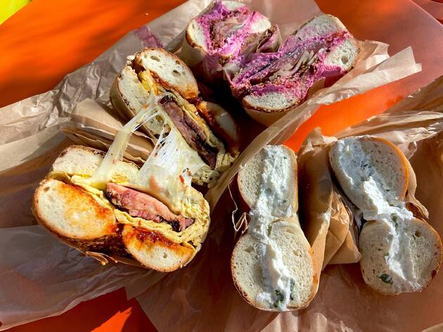 Belle's Bagels Highland Park A pastrami breakfast sandwich, beet cream cheese Loxwich, and scallion cream cheese bagel at Belle's Bagels Highland Park