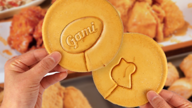 Two honeycomb toffee candies carved with the silhouette of a bird and with a circle that is stamped with the word Gami.